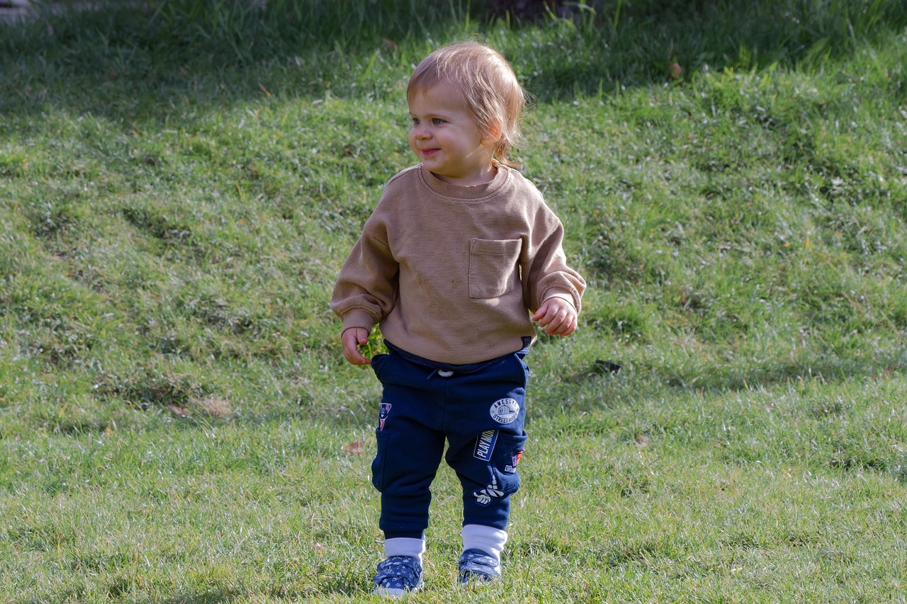 You see a child playing in the grass at the park. What do you do?